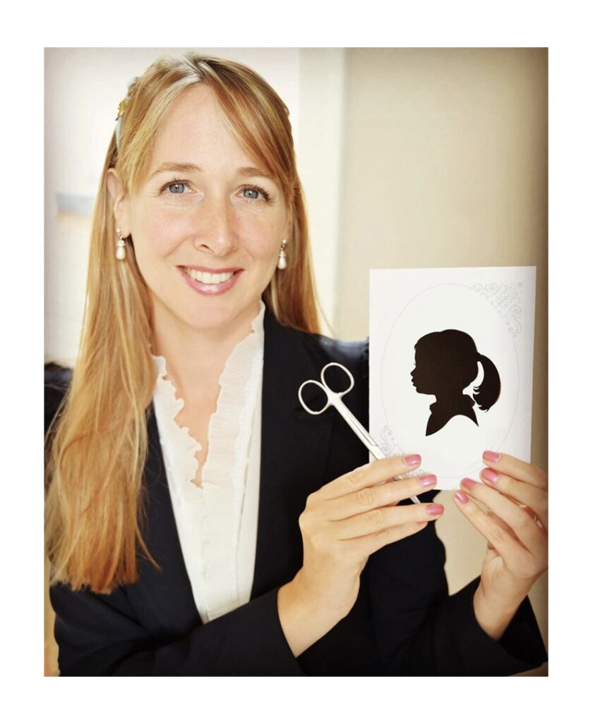 Artist Alison Russell with a paper-cut silhouette